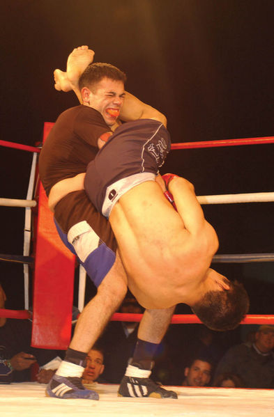 MMA cage fighters throwing